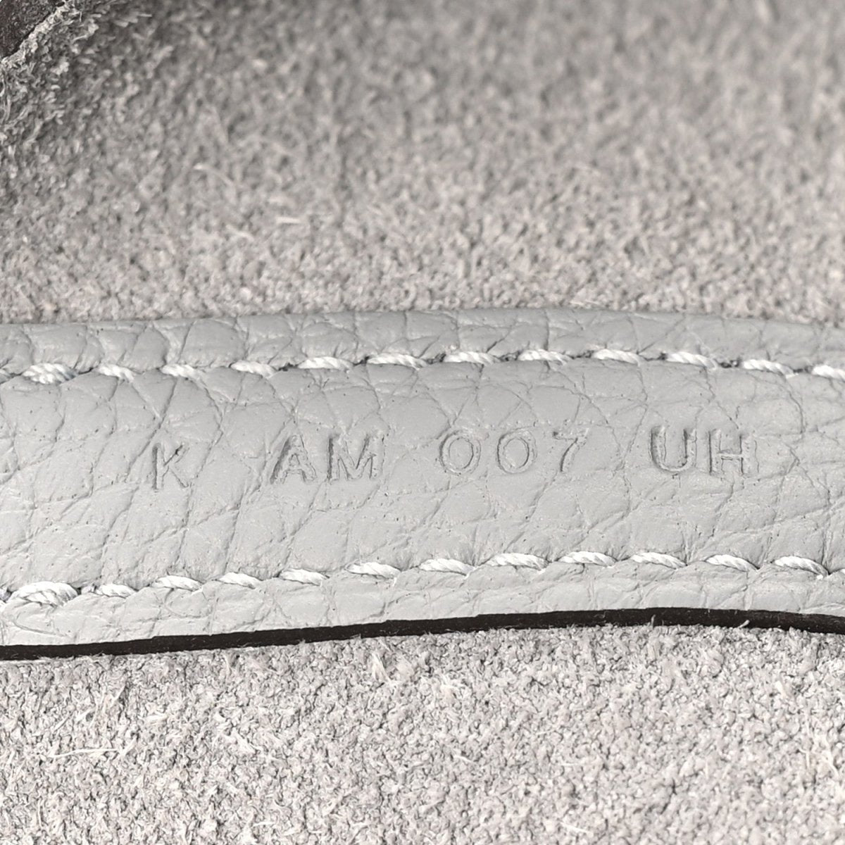 Light grey leather serial stamp on stitched edge