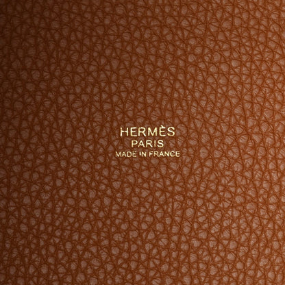 Hermès Paris leather stamp on orange-tan grain