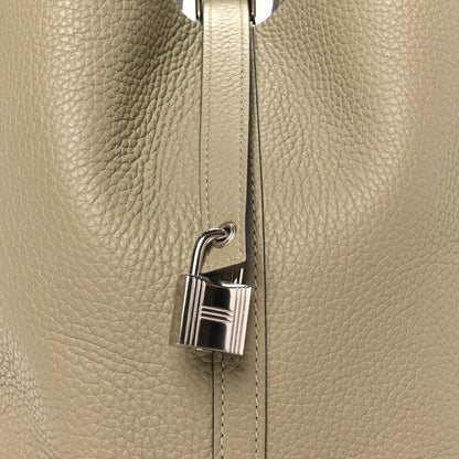 Sauge leather handbag with silver lock clasp on front seam