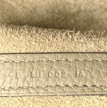 Leather edge with embossed lettering and visible stitching
