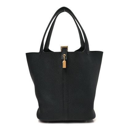 Black leather tote bag with central lock detail and structured top handles.