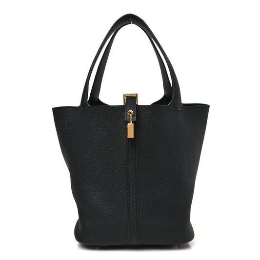 Black leather tote bag with central lock detail and structured top handles.