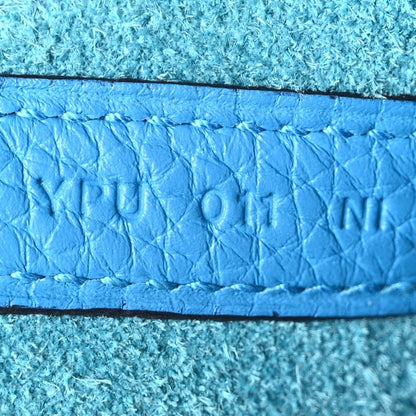 Blue leather interior edge with embossed lettering and small stamp details