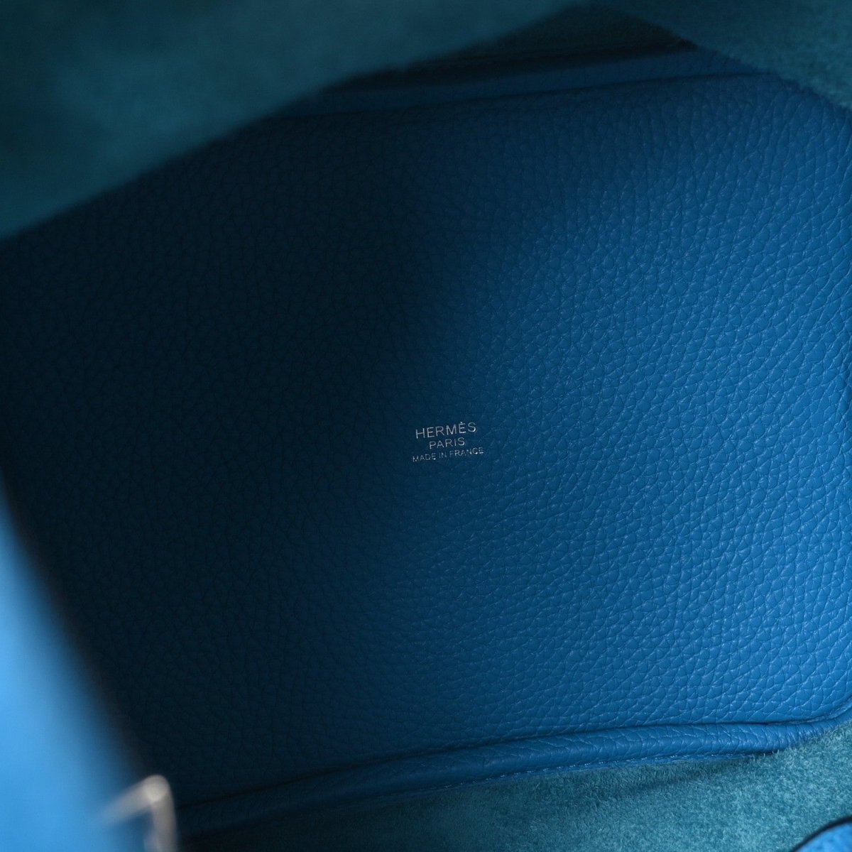 Blue leather interior with embossed Hermes Paris marking near the seam