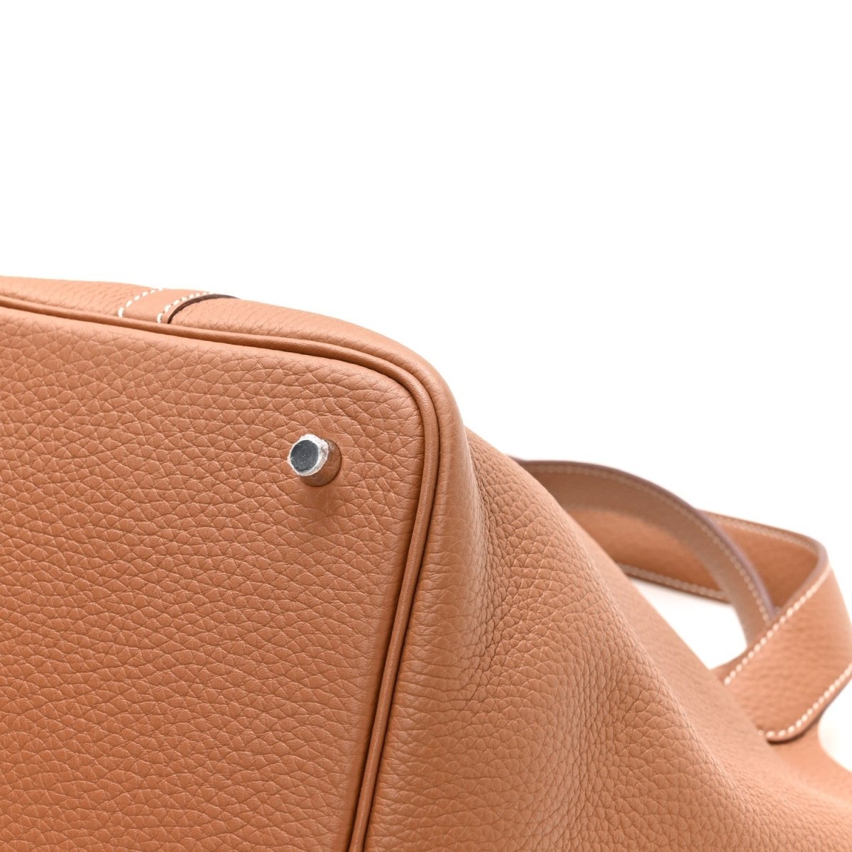 Tan leather tote with round silver lock and top edge stitching detail