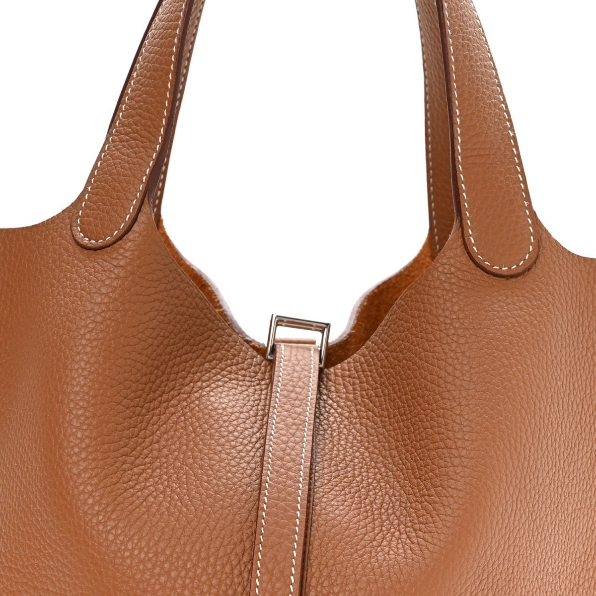 Tan leather tote handles with central lock bar and top seam stitching