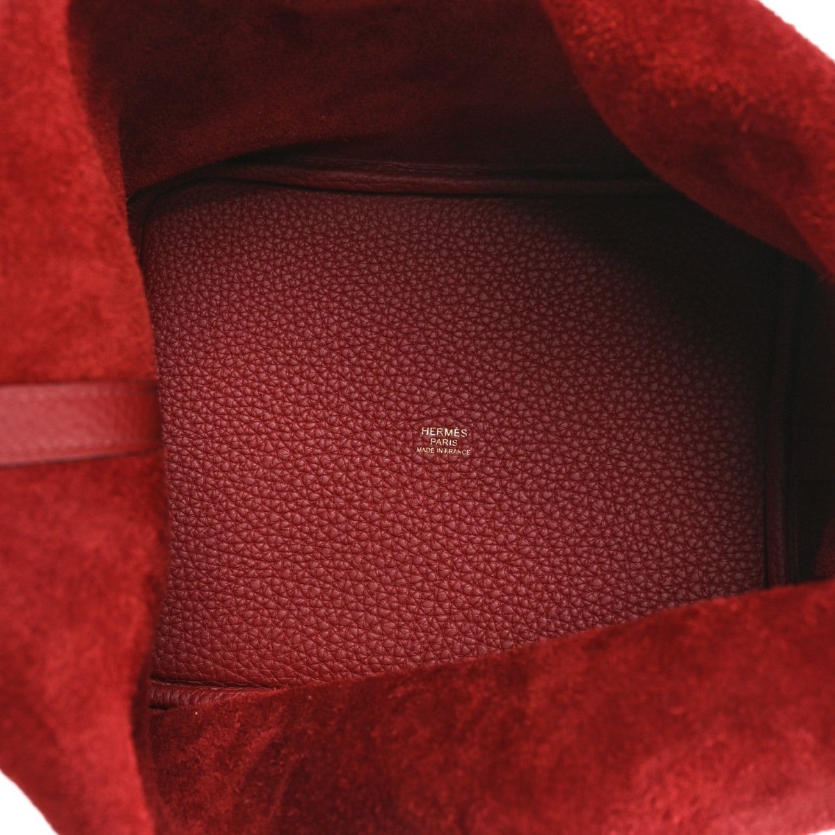 Red leather mini tote interior with embossed logo on suede lining