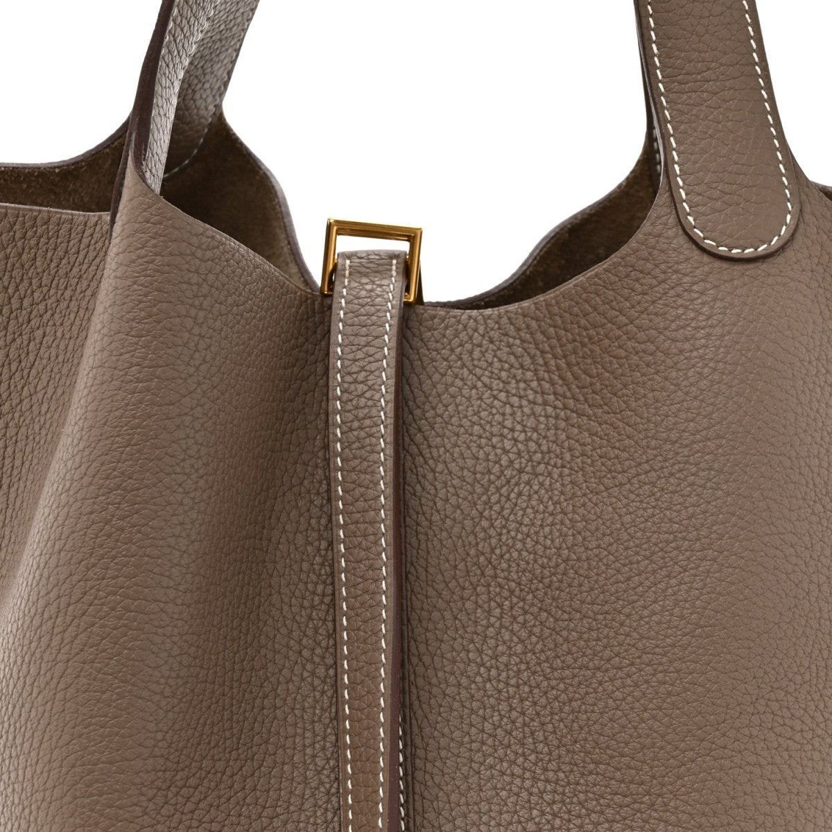 Taupe leather tote with gold lock clasp and contrast-stitched zipper