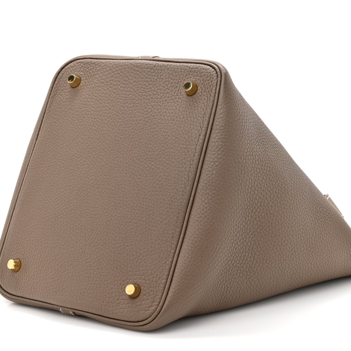 Taupe leather tote bag with gold corner studs and top zipper