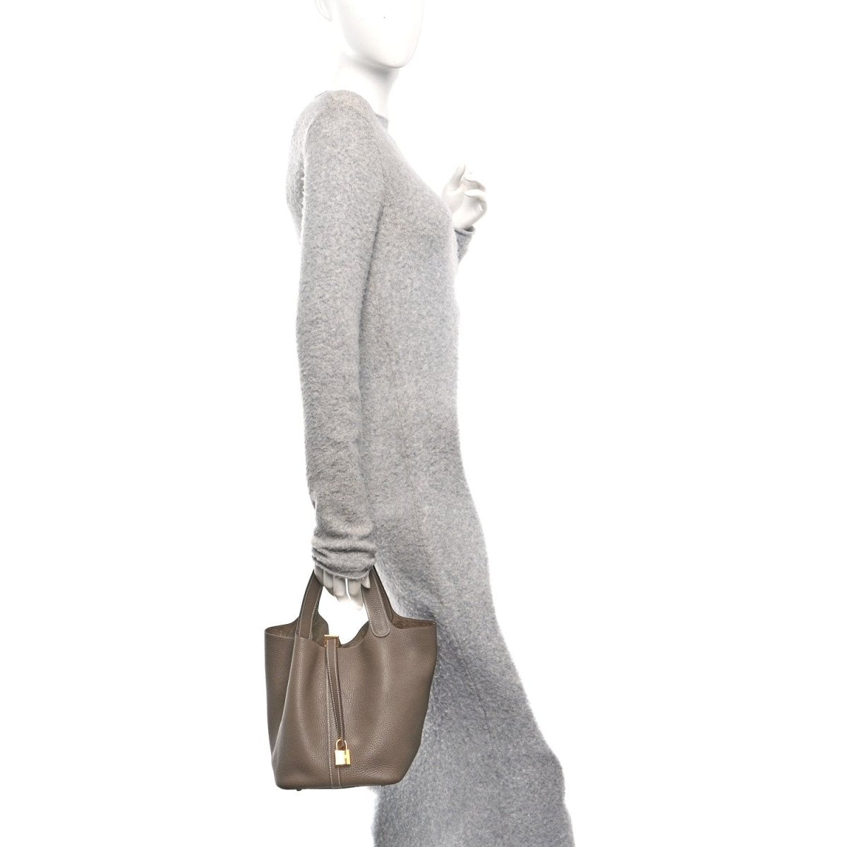 Taupe leather tote bag with gold lock, viewed from side