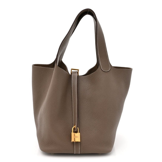 Taupe leather tote bag with gold lock and top handles