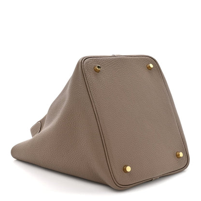 Taupe leather tote bag with flat base and gold corner studs