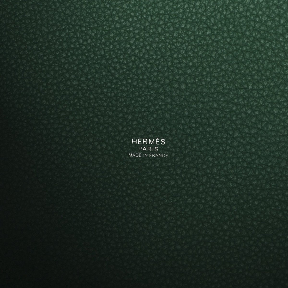 Green leather interior panel with stamped brand and “Made in France” text