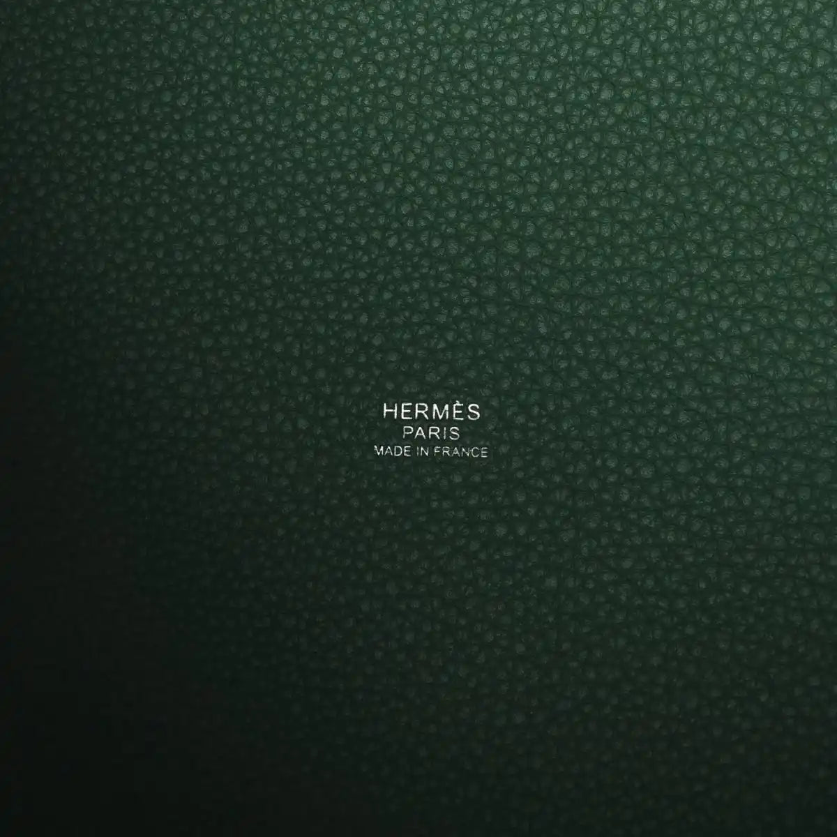 Green leather interior panel with stamped brand and “Made in France” text