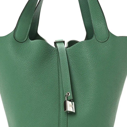 Green leather tote bag front with top handles and center zip lock