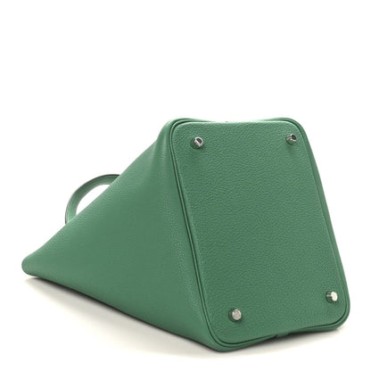 Green leather tote bag with triangular base and metal snap hardware