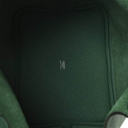Green leather interior panel with small stamped brand text