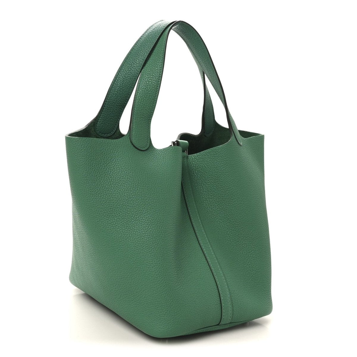 Green leather tote bag with structured sides and top handles, side view
