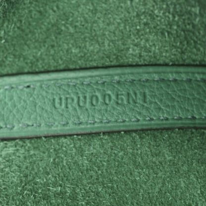 Close-up of green leather trim with embossed serial-style text