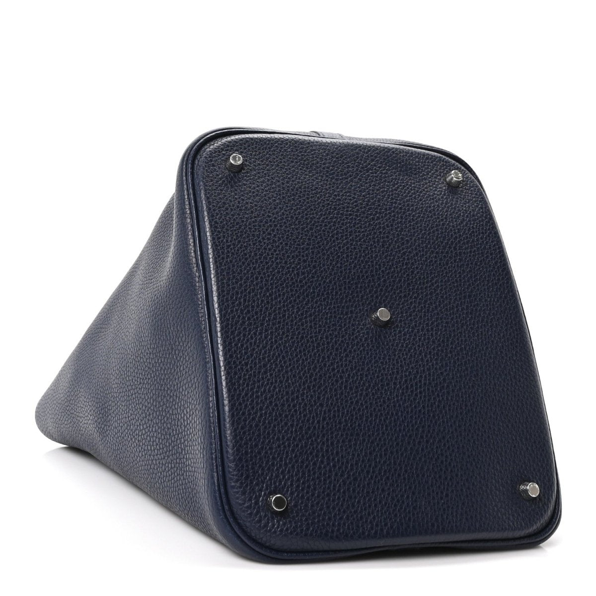 Navy leather tote bag with triangular fold and corner studs, angled side view