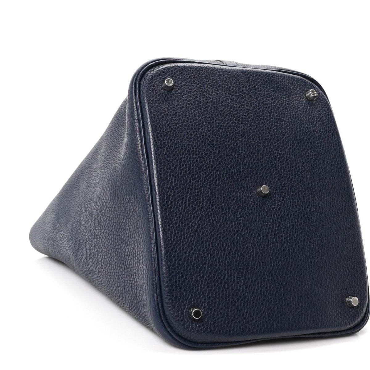 Navy leather tote bag with corner hardware and top handle loop, angled view
