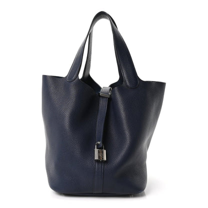 Navy leather tote bag with top handles and metal lock detail, Picotin style