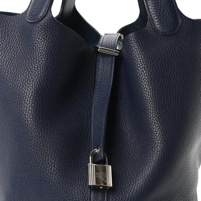 Dark navy leather tote with metal lock clasp and top strap detail