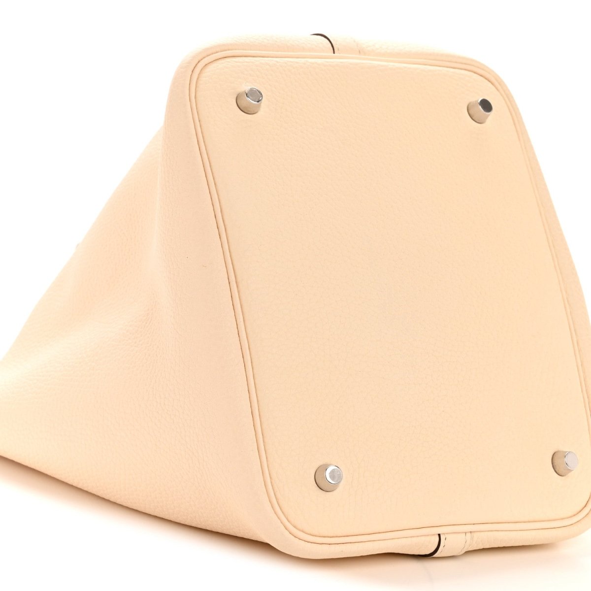 Light beige leather bucket bag with corner studs and top panel seam