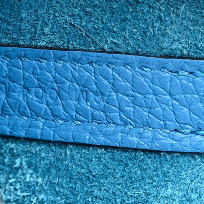 Blue pebbled leather panel close-up with stitched trim
