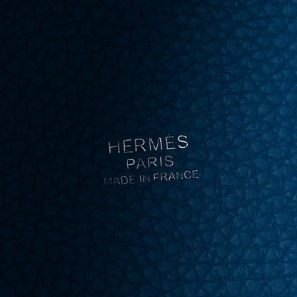 Blue leather close-up with embossed text: HERMES PARIS MADE IN FRANCE