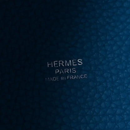 Blue leather close-up with embossed text: HERMES PARIS MADE IN FRANCE