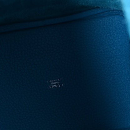 Blue pebbled leather close-up with textured grain and stitched edge
