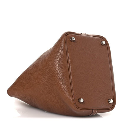 Brown leather structured mini bag with corner hardware studs and side panel seam