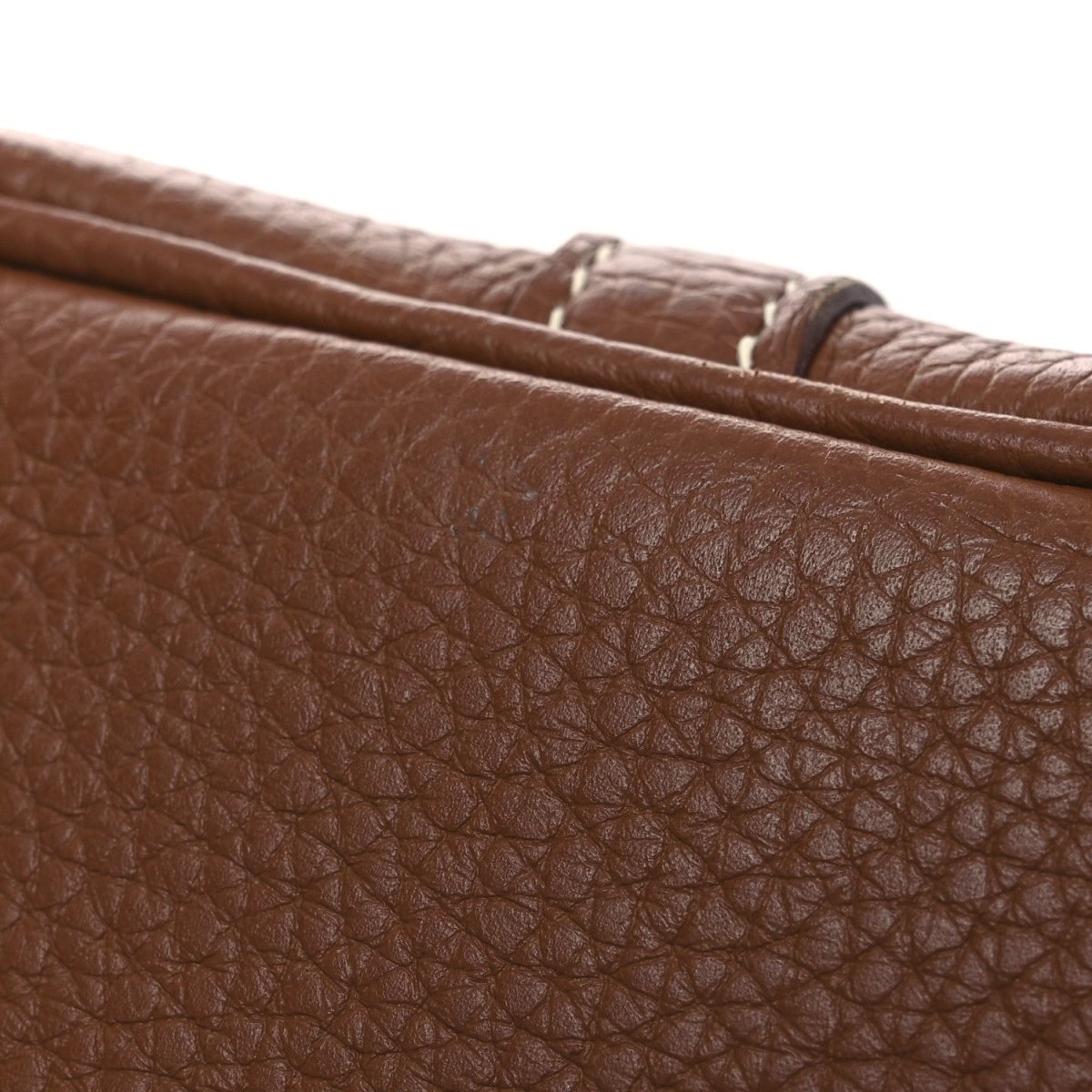Brown leather bag with pebbled texture and stitched edge detail