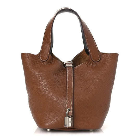 Brown leather tote bag with top handles and front lock detail, gold-tone hardware