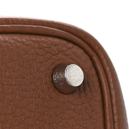 Brown leather bag panel with round snap-button metal hardware