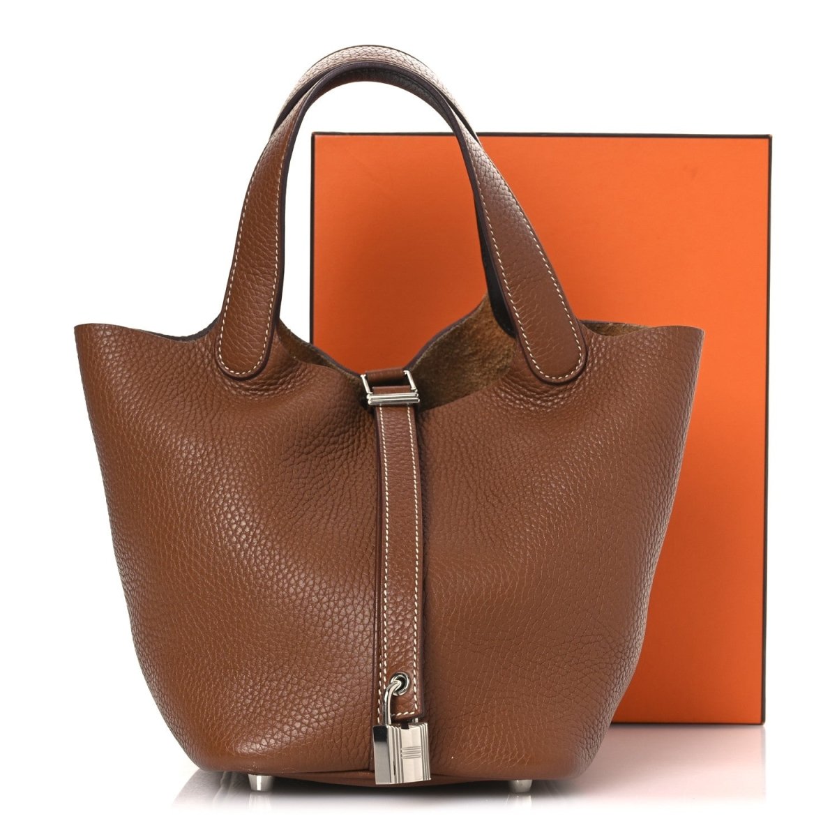 Brown leather tote bag with top handles and vertical lock strap detail