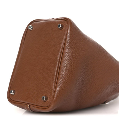 Hermes Picotin lock bag side view in brown textured leather with metal rivets