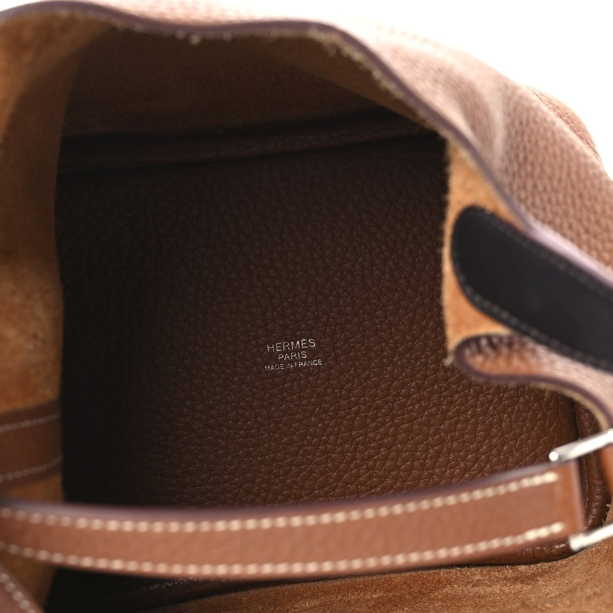 Brown leather bag lining with Hermes Paris logo and visible interior edge stitching