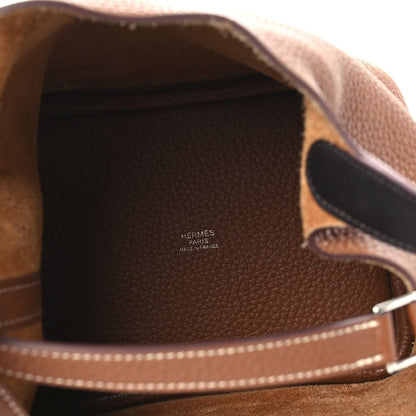 Brown leather bag lining with Hermes Paris logo and visible interior edge stitching
