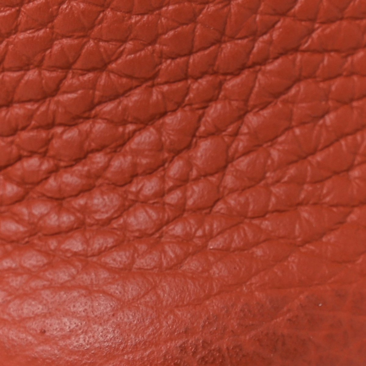 Red leather tote exterior with quilted texture and visible grain pattern