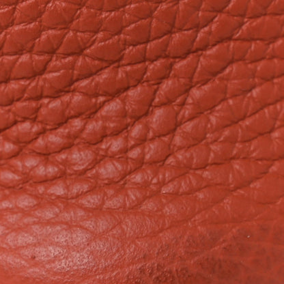 Red leather tote exterior with quilted texture and visible grain pattern