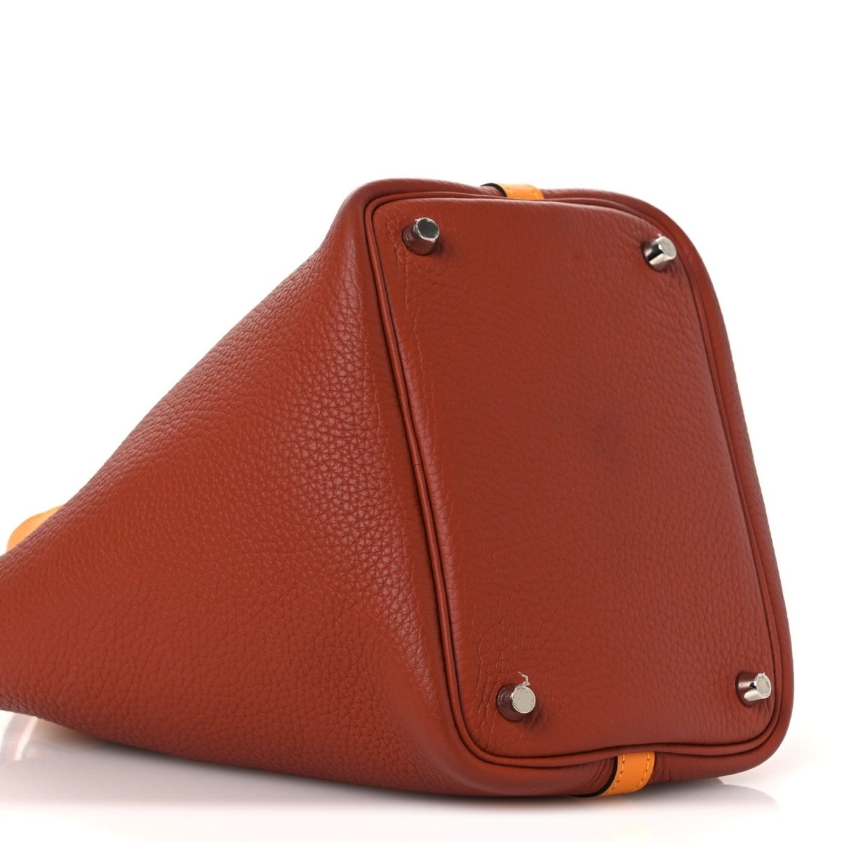 Copper-brown leather tote with corner rivets and curved top handle