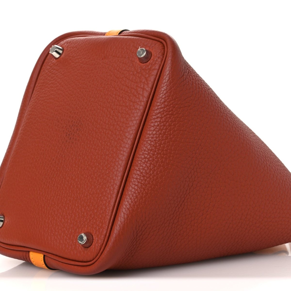 Copper-brown leather tote with tan strap and silver rivets at corners