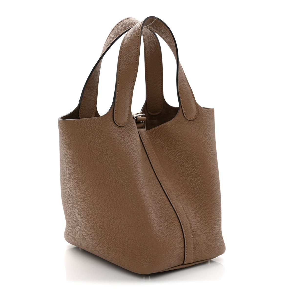 Beige leather bucket bag with curved top handles and front vertical side seam