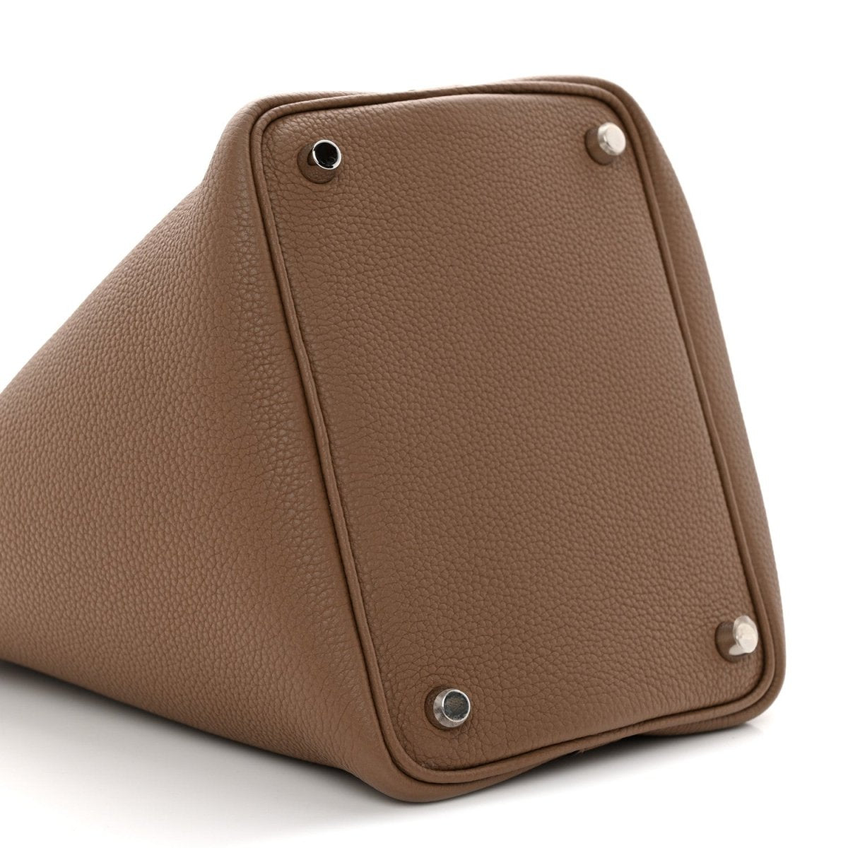 Beige leather bucket bag side view with corner studs and vertical panel seam