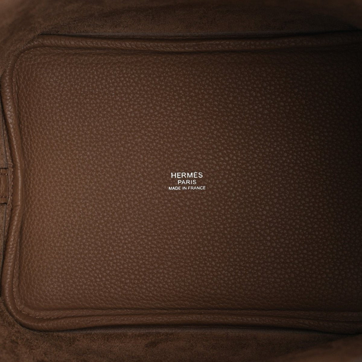 Hermes Paris leather bucket bag exterior with embossed logo on front panel