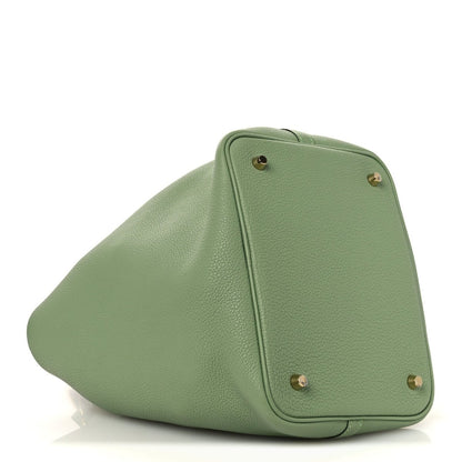 Green leather bucket bag with structured top panel and gold-tone hardware