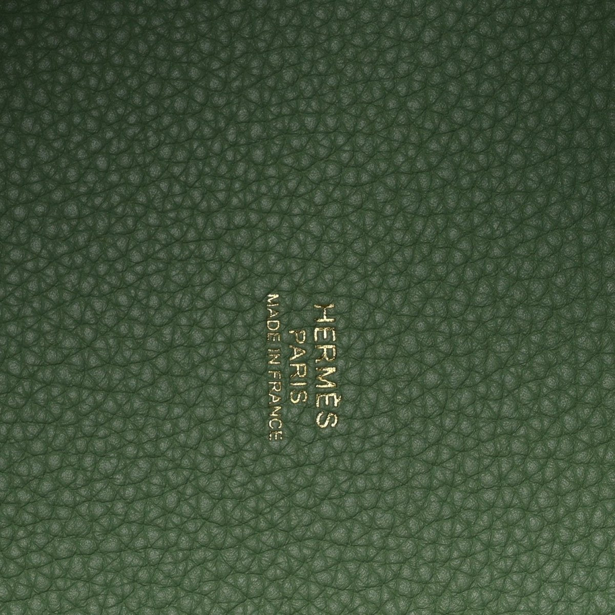 Green pebbled leather interior with centered embossed brand mark