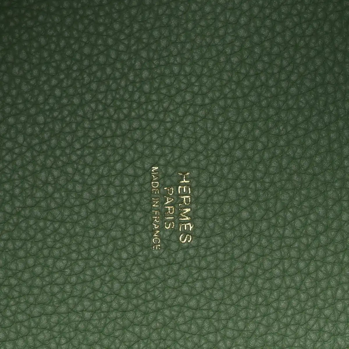 Green pebbled leather interior with centered embossed brand mark
